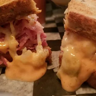 two sandwiches with cheese and meat