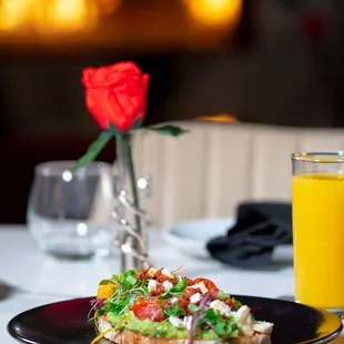 a plate of food and a glass of orange juice