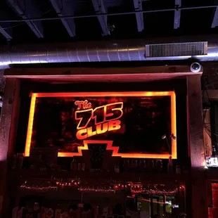 a neon sign above a bar