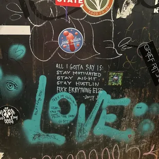 Graffiti adorned bathroom stalls