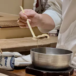 The anago is brought out, briefly allowed to drain before being married w shari.