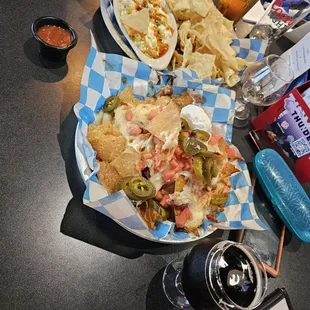 Up Close, TnT Nachoes and a 9.5% Salted Caramel Porter, in the distance Crab Rangoon Nachoes and a Clydes Caramel Cream beer.