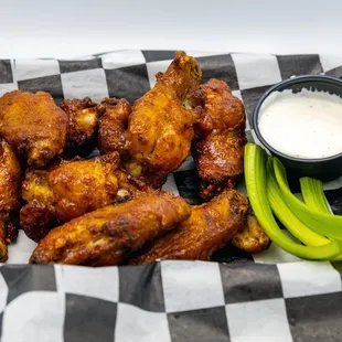 a basket of chicken wings and celery