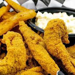 a basket of fried fish and fries