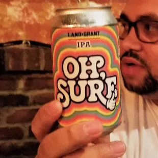 a man holding a can of beer