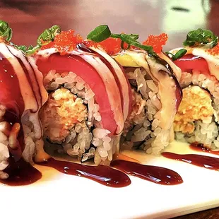Vista Roll~~Real crab meat, avocado, spicy sauce topped with tuna, eel sauce, sesame dressing, chili oil, masago and green onions.