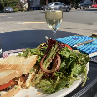 Yummy blackened salmon sandwich with green salad.