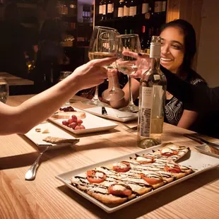 three women toasting at a table