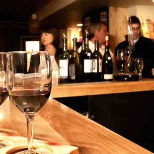 a row of wine glasses on a bar
