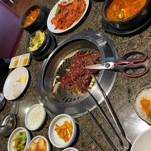 Kimchi soup, steamed egg, spicy pork, beef bulgogi, kimchi sides.