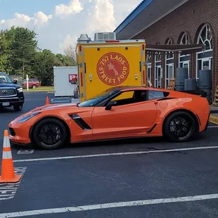 a orange sports car parked in a parking lot