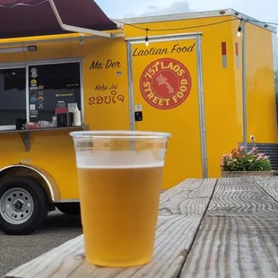 a glass of beer on a picnic table