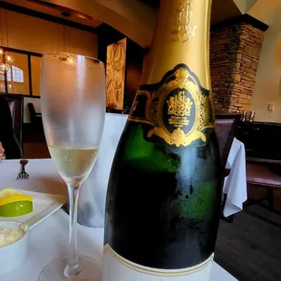 a bottle of champagne and a glass of wine