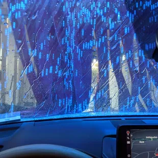 the dashboard of a car with a view of a city through the windshield