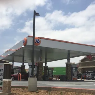 a gas station with a truck parked in front of it