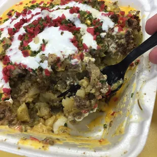 Potatoes with cheese, ground beef, onions, mushrooms, and sour cream