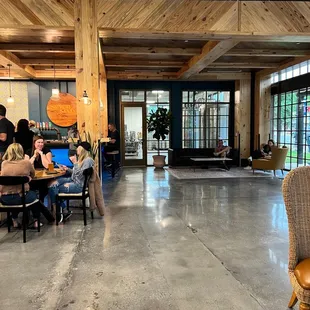 people sitting at tables and working on laptops