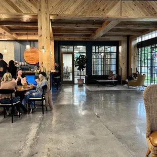 people sitting at tables and working on laptops