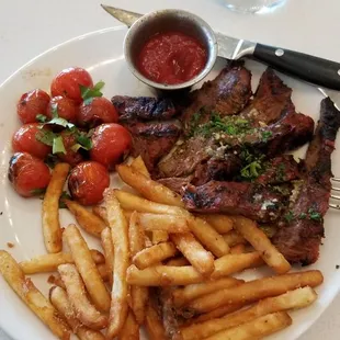 Excellently seasoned and cooked steak, roasted baby tomatoes and crispy fries.