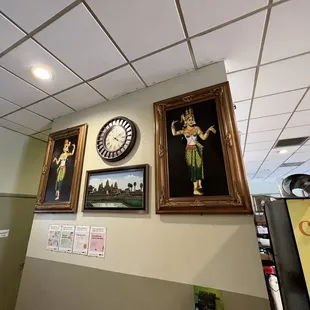 a clock and paintings