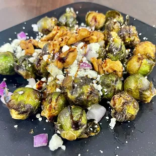 Brussels sprouts with candied nuts, red onion, goat cheese. Delicious!