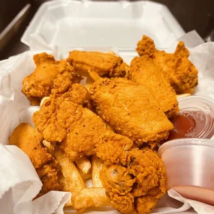 a tray of fried chicken and fries