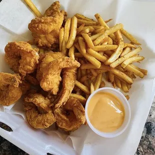 a basket of fried chicken nuggies and fries