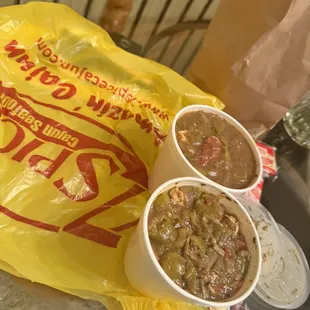 two bowls of chili and a bag of chips