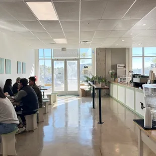 people sitting at tables in a coffee shop