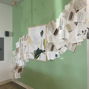 a green wall with a bunch of papers on it