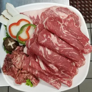 Combo A includes Beef Brisket, Rib Eye Steak, and your choice of either Marinated Boneless short ribs or Pork Belly!