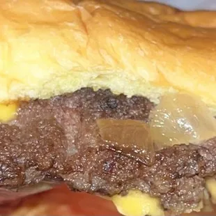 a beef sandwich with cheese and onions