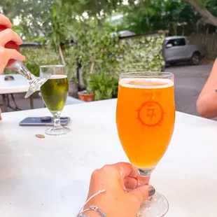 a person holding a glass of beer