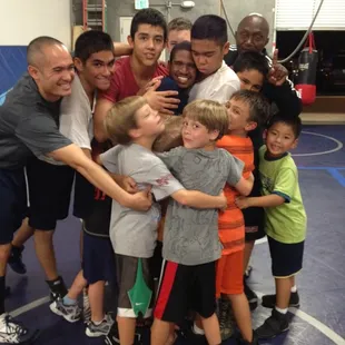 Kids wrestling class saying bye to one of the students
