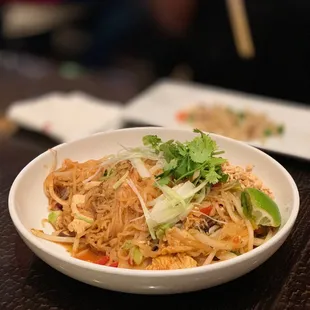 a bowl of noodles and chopsticks