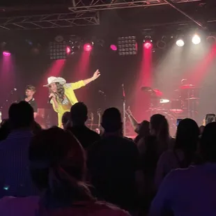 a man in a cowboy hat on stage