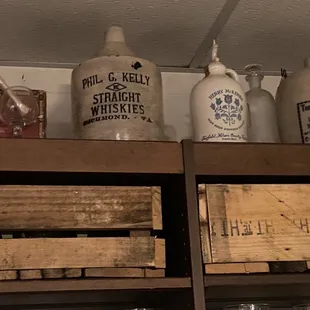 a shelf of bottles and crates