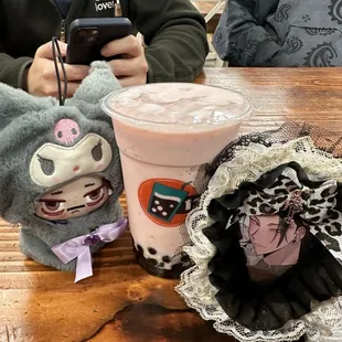 two stuffed animals and a drink