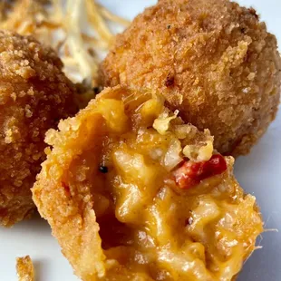a close up of a fried macaroni and cheese ball