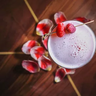 a drink with strawberries on a stick