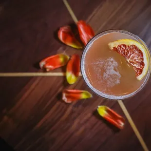 a grapefruit cocktail on a wooden table