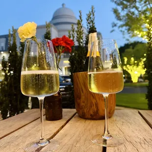 two glasses of wine on a wooden table