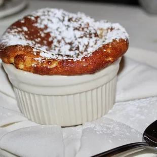 The House-Made Soufflé was made with Grand Marnier and sides of Chocolate, Vanilla Crème Anglaise, Chocolate Sauce and Mixed Berry Compote.