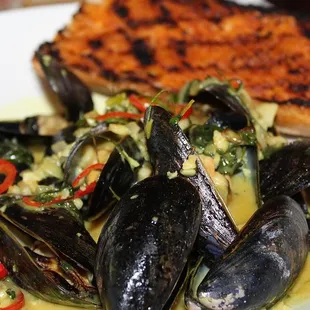 The Prince Edward Island Mussels were made with Coconut Curry Broth, Dill, Thai Basil, &amp; Grilled Baguette.