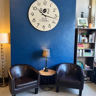 two chairs in front of a clock