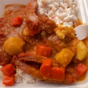 a plate of meat, rice, and vegetables