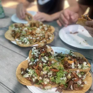 two people eating at a picnic table