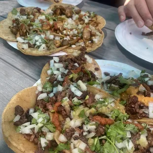 two plates of tacos on a picnic table