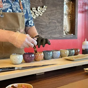 a person preparing bowls of food