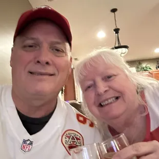 a man and a woman holding wine glasses